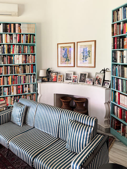 Cozy library living room with striped sofa and bookshelves – Beautiful Homes