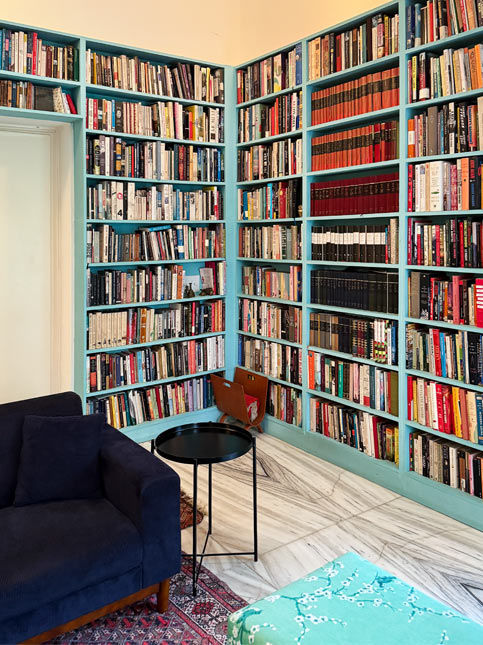 Home library with teal bookshelves and reading corner – Beautiful Homes