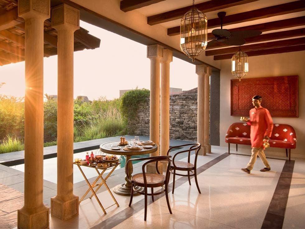 Stone pathways and lantern-lit courtyards at Aramness Gir set the tone for a wilderness retreat – Beautiful Homes