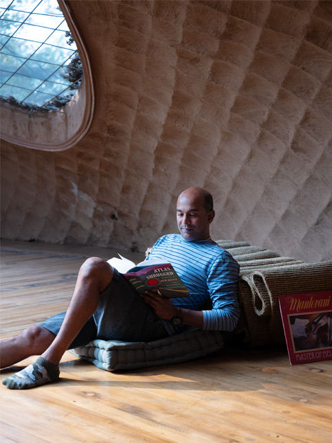 Man reading in sculptural textured interior – Beautiful Homes