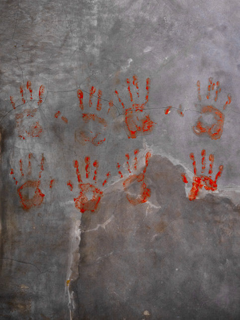 Red handprints on textured concrete wall – Beautiful Homes