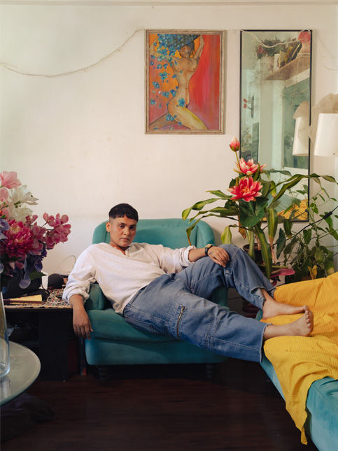 Man relaxing on armchair in artistic modern living room – Beautiful Homes
