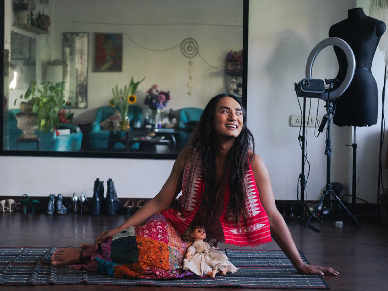 Person in traditional red attire with doll in creative studio – Beautiful Homes