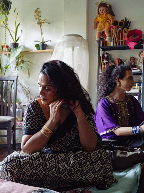 Two people in traditional attire sitting in a well-lit room – Beautiful Homes