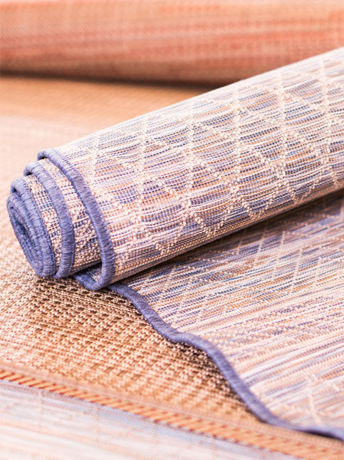 Close up of rolled textured jute and cotton area rug – Beautiful Homes