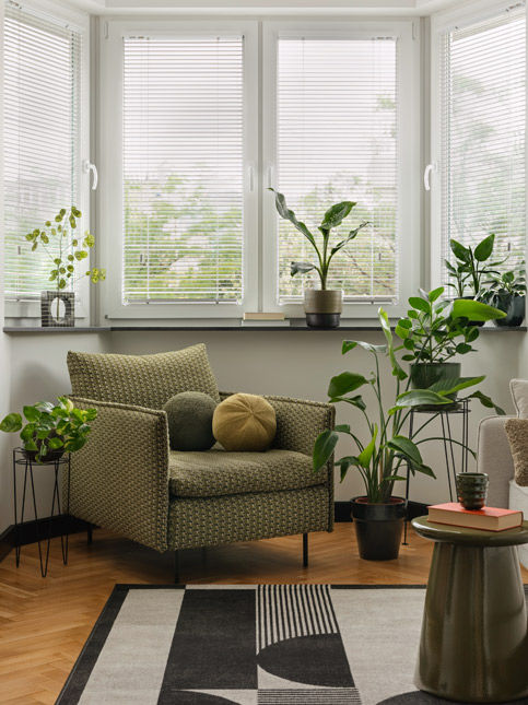 Modern living room with blue wingback chair and sheer embroidered curtains – Beautiful Homes