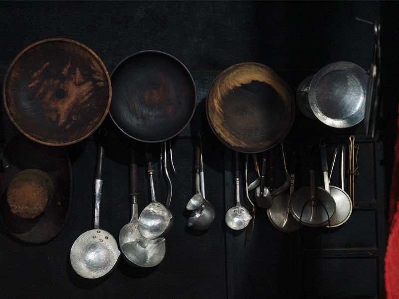 Cooking utensils and ladles hanging in traditional kitchen – Beautiful Homes