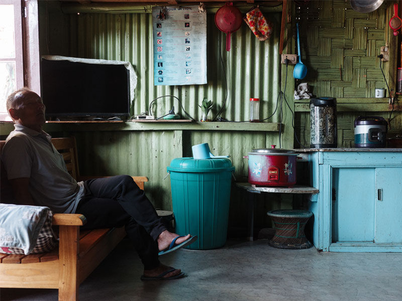Man sitting on wooden sofa in kitchen – Beautiful Homes