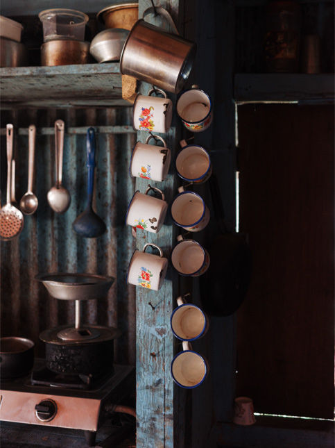 Stainless steel utensils and enamel mugs on kitchen rack – Beautiful Homes