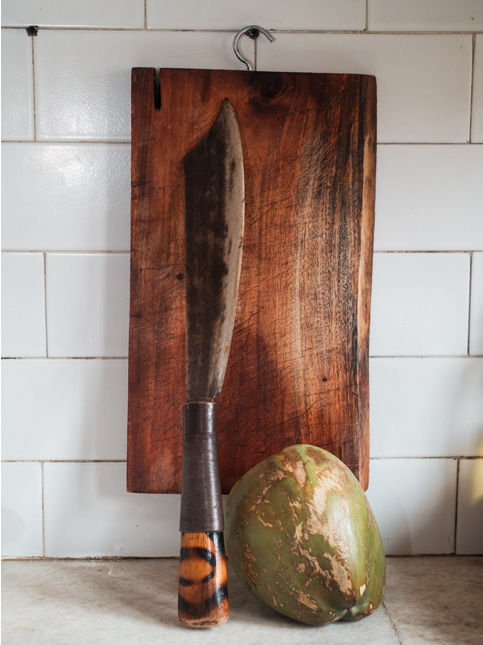 Traditional dao knife and coconut on cutting board – Beautiful Homes