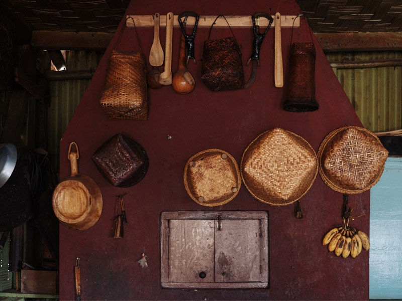 Traditional woven baskets and utensils on kitchen wall – Beautiful Homes