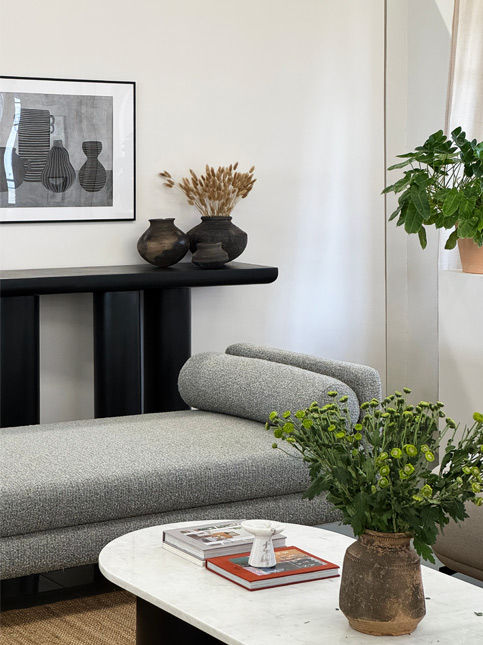 Modern grey chaise lounge with monochrome art and vases – Beautiful Homes