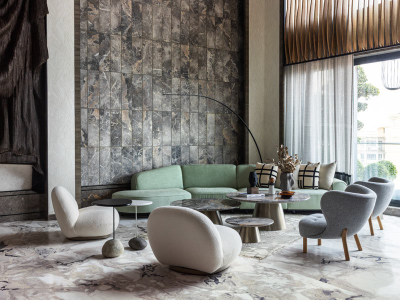 Modern living room with curved green sofa and marble flooring – Beautiful Homes
