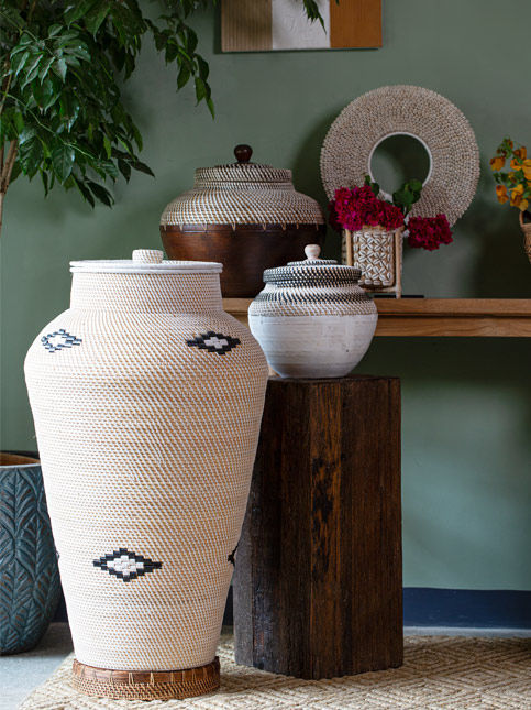 Tall woven baskets and earthenware vases by the wall – Beautiful Homes