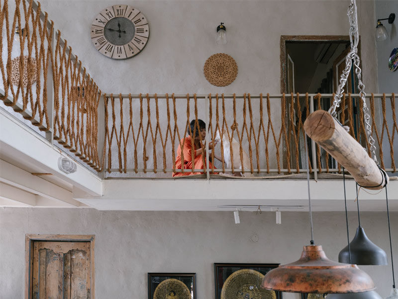 Beautiful home loft balcony with rope railing hanging pendant lights and a pet dog – Beautiful Homes