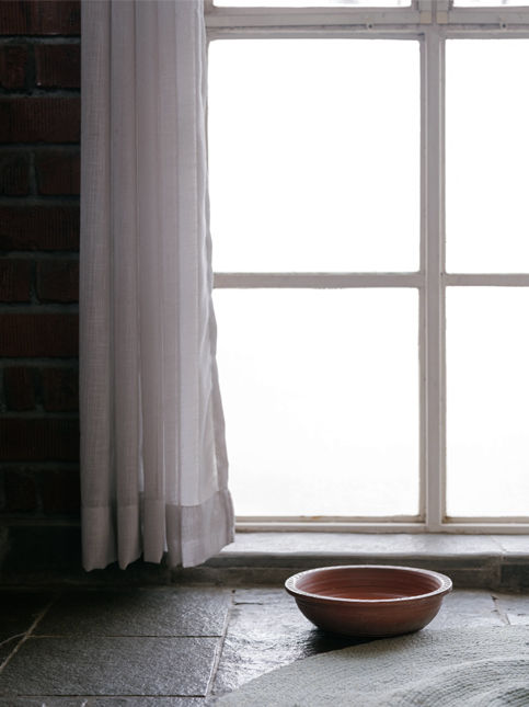 Traditional terracotta bowl on stone floor by bright window – Beautiful Homes