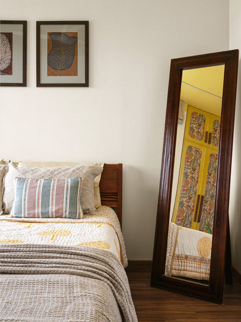 Another bedroom in the house with the standing, full-length mirror reflects the wardrobe in yellow, with the – Beautiful Homes