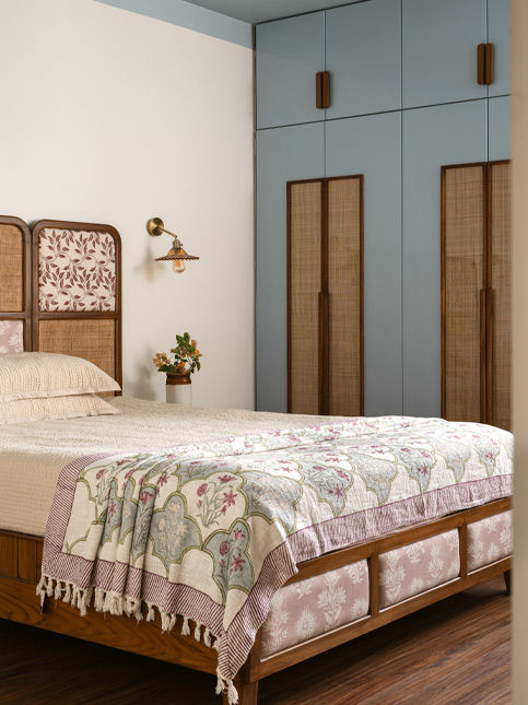 Master bedroom features a wardrobe colour that extends to the ceiling and a teakwood bed upholstered in fabric from Asian Paints – Beautiful Homes