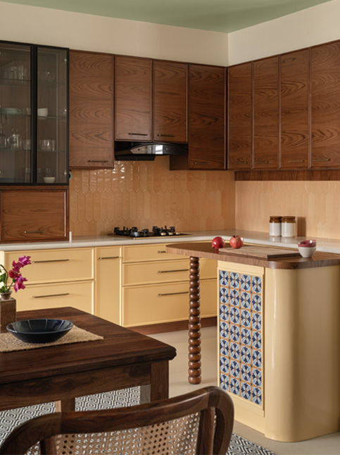 The bright yellow kitchen has teakwood cabinets to offset the brightness – Beautiful Homes