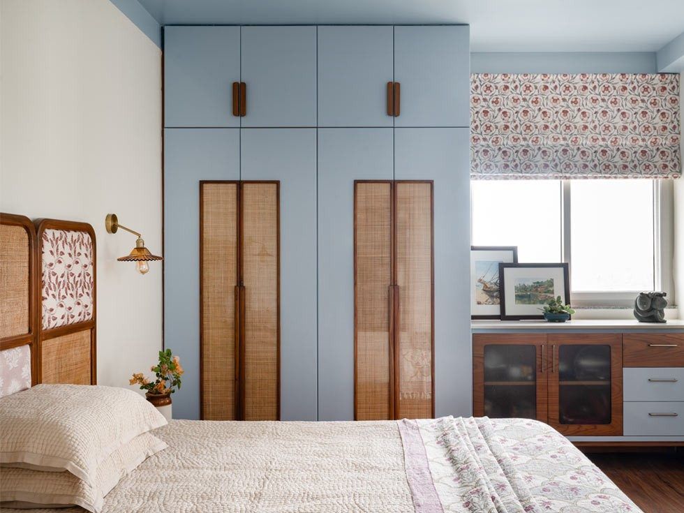 In the master bedroom, the colour of the wardrobe is extended all the way across the ceiling, keeping the walls neutral – Beautiful Homes