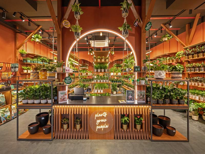 Ugaoo urban jungle store with terracotta archways and plants - Beautiful Homes