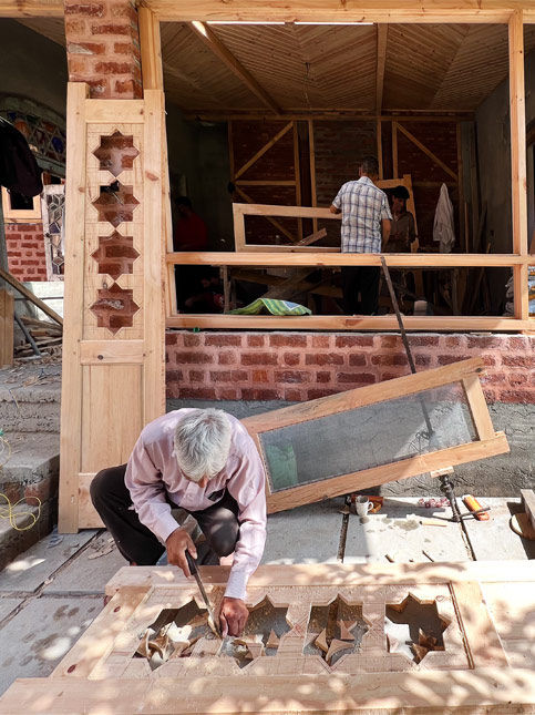 Kashmiri craftsmanship and hand-drawn door design detail - Beautiful Homes