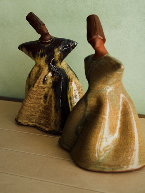 Ceramic dervish sculptures in mid swirl inside Byculla home - Beautiful Homes