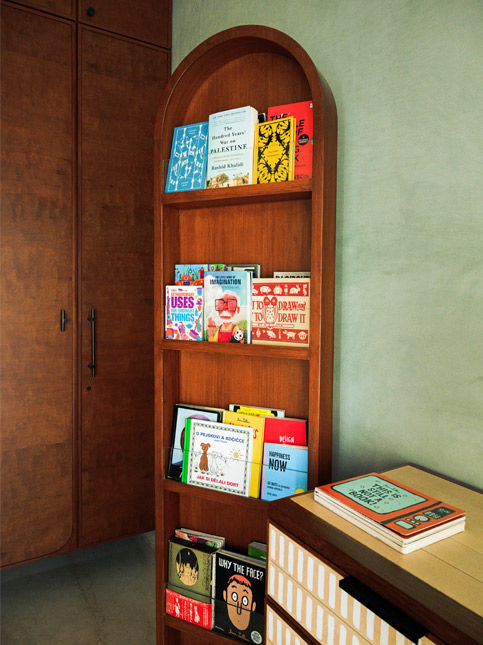 Curved bookshelf mimicking movement inside Huzefa Rangwala home - Beautiful Homes