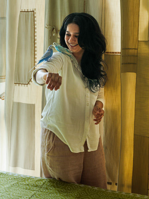 Tasneem Rangwala with budgies inside Bayt-ul-Sumud - Beautiful Homes