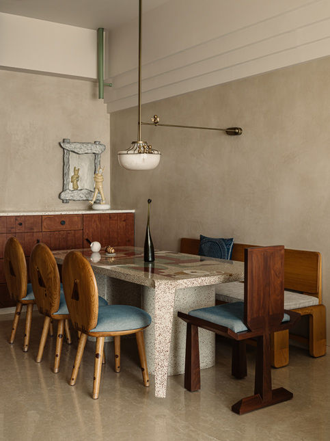 Terrazzo dining table with marquetry bird chairs in Byculla home - Beautiful Homes
