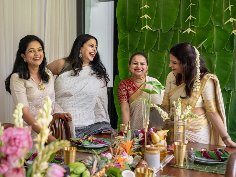 Varsha Menon with interior stylists Fymin Naif and Nimitha Harith at the Onam table - Beautiful Homes