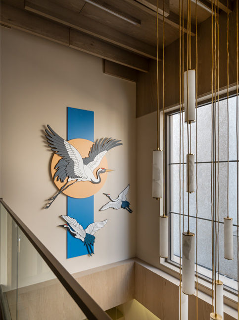 Bird motif artwork along staircase wall in Ahmedabad flat - Beautiful Homes