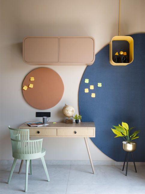 Modern corner with floating shelves and bright blue accent wall - Beautiful Homes