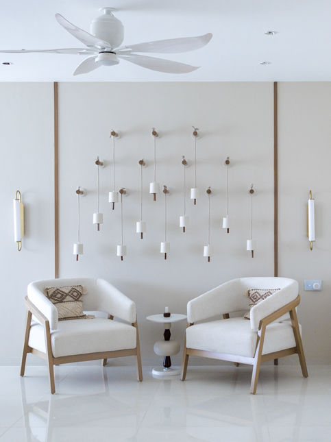Living room nook with curved accent chairs and ceramic bells - Beautiful Homes