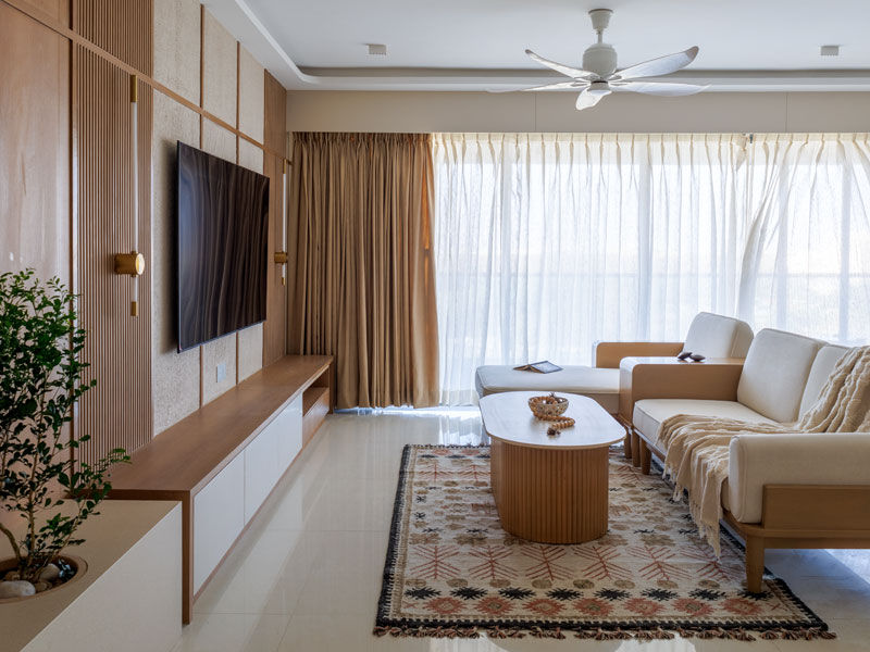 Scandinavian living room with teakwood sofa and wooden louvers - Beautiful Homes