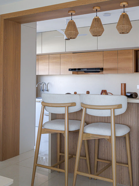 Semi-open kitchen with breakfast counter and wooden barstools - Beautiful Homes
