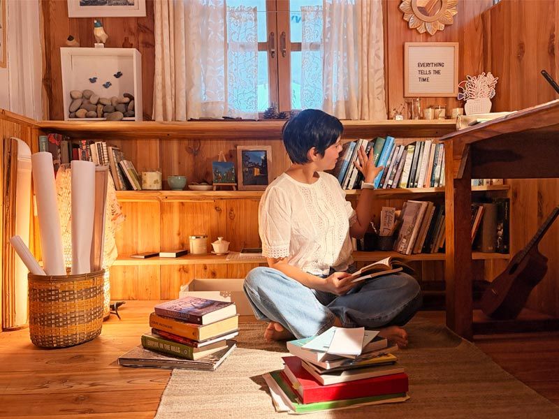 Janice Pariat in Shillong writing shed surrounded by books and trees - Beautiful Homes