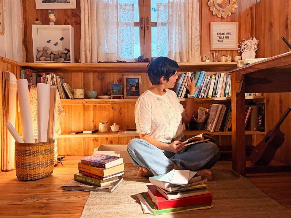 Janice Pariat in Shillong writing shed surrounded by books and trees - Beautiful Homes