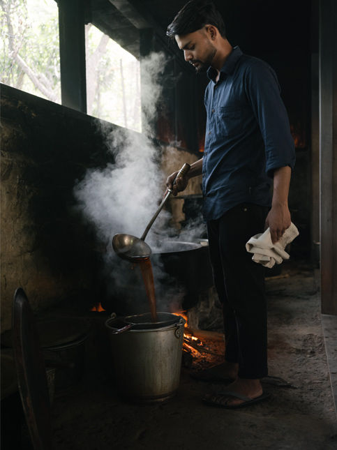 Artisan preparing steaming dye bath using traditional hand-dyeing technique - Beautiful Homes