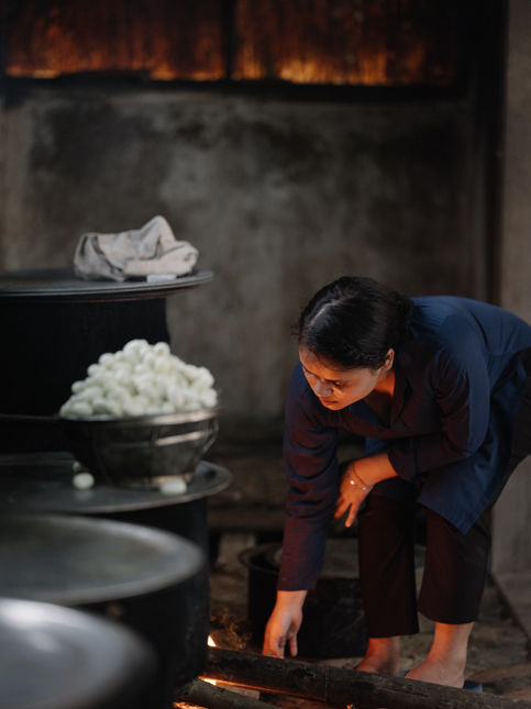 Artisan tending cocoons for releasing silk fibres - Beautiful Homes