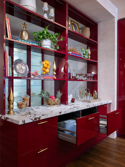 Red modular kitchen with integrated refrigerator and marble backsplash - Beautiful Homes