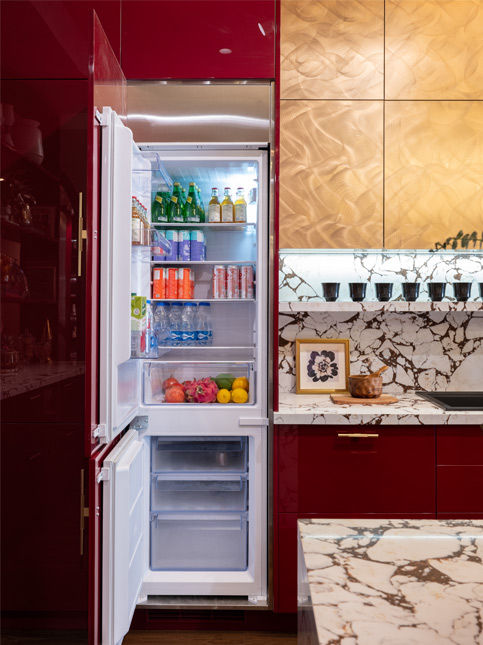 Red modular kitchen with tall pull-out pantry and built-in appliances - Beautiful Homes