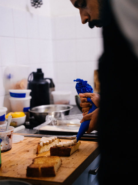 Liver pâté being piped onto toasted brioche during Apartment popup service – Beautiful Homes
