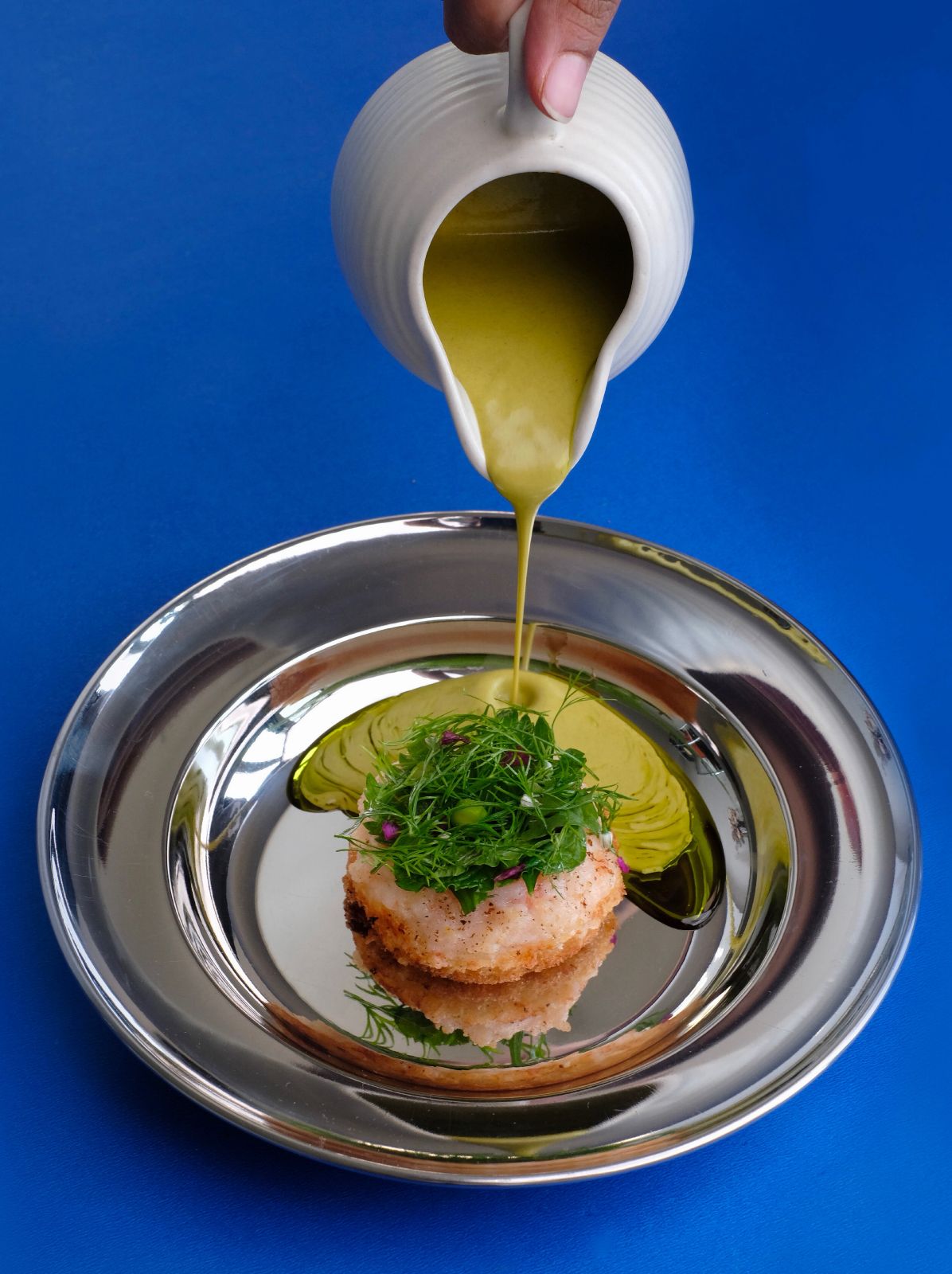 Prawn toast topped with herbs as curry sauce is poured onto the plate – Beautiful Homes