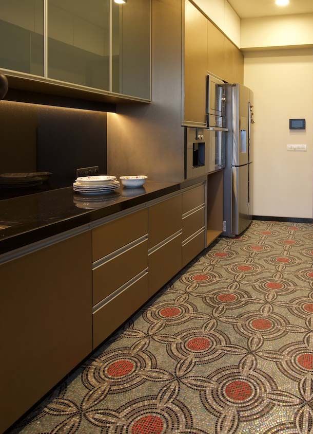Metallic and wood themed modular kitchen design with the black countertop - Beautiful Homes