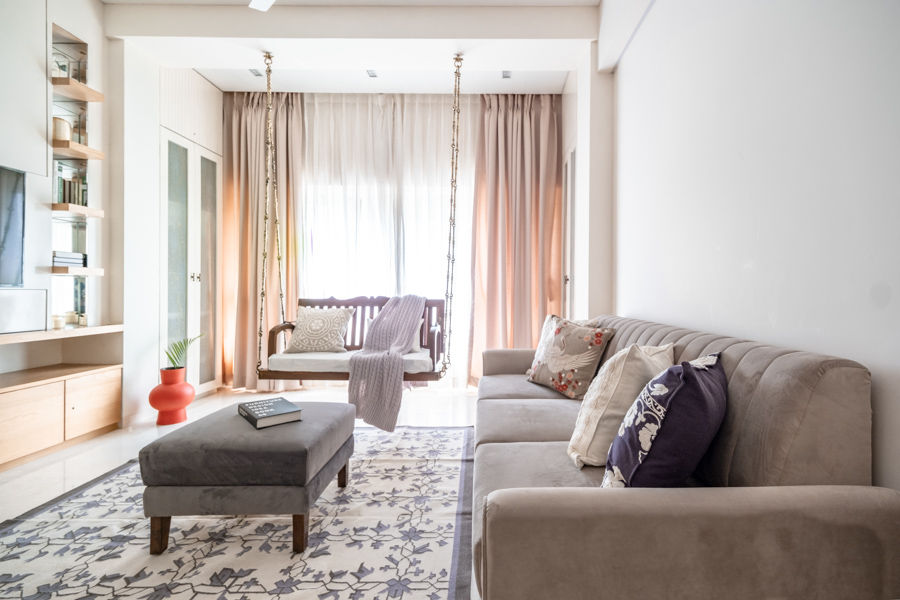 Small family room design with a swing, plush sofa and coffee table, printed carpet