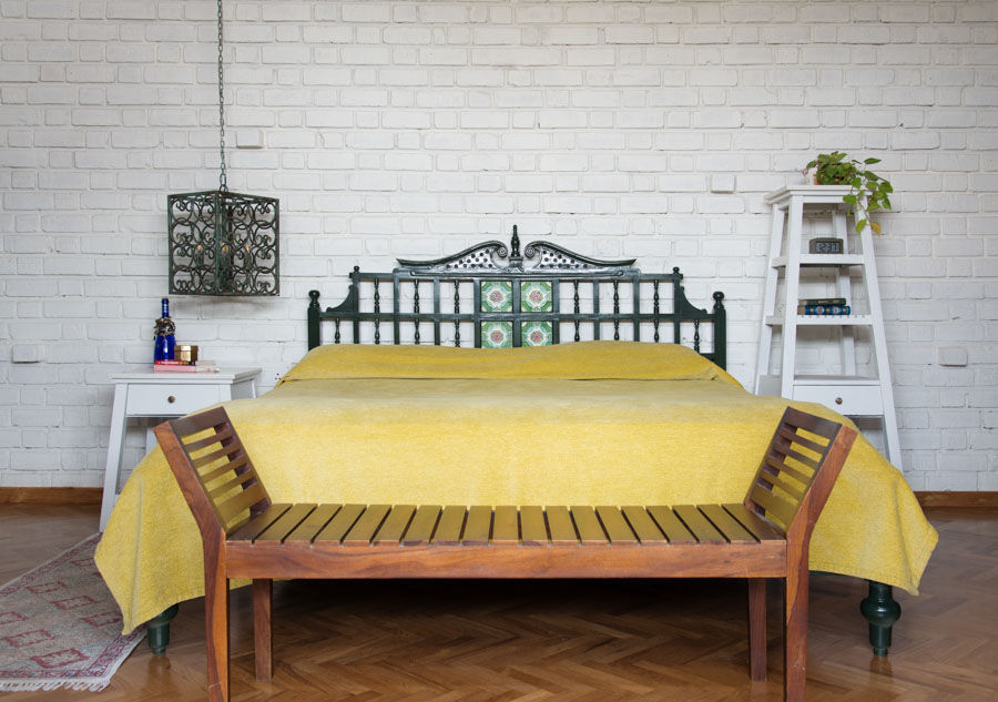White-painted brick walls in Indian bedroom design, wooden bed décor with intricate headboard - Beautiful Homes