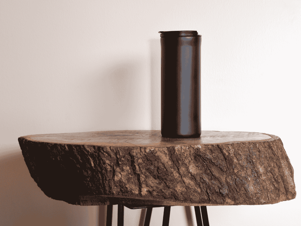 Circular Wooden Table With Black Tumbler - Beautiful Homes