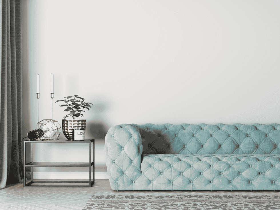 Light Blue Tufted Sofa With Side Table And Decorative Items - Beautiful Homes