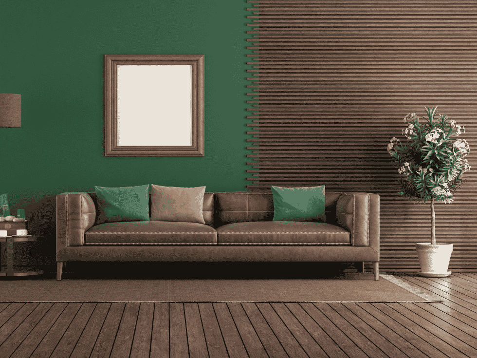 Brown Leather Sofa With Cushions Against Green And Wooden Wall - Beautiful Homes